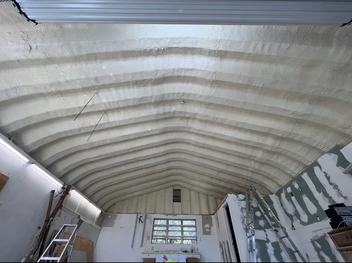 Spray polyurethane foam applied to the underside of a metal roof deck in Adelphi